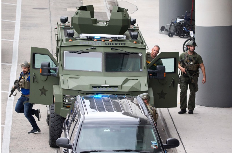 Law enforcement personnel arrive in an armored car outside Fort Lauderdale–Hollywood International Airport, Friday, Jan. 6, 2017, in Fort Lauderdale, Fla. A gunman opened fire in the baggage claim area at the airport Friday, killing several people and wounding others before being taken into custody in an attack that sent panicked passengers running out of the terminal and onto the tarmac, authorities said. (AP Photo/Wilfredo Lee)