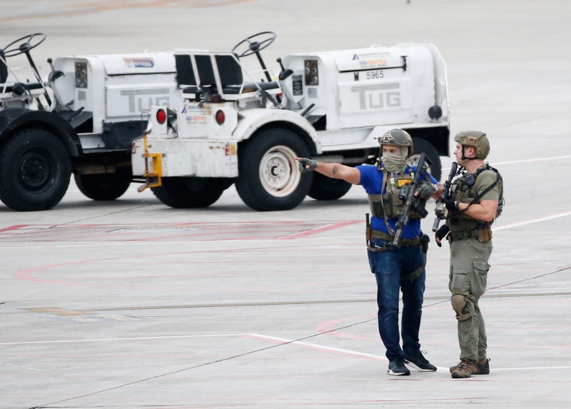 Law enforcement officers are shown on the tarmac at Fort Lauderdale–Hollywood International Airport, Friday, Jan. 6, 2017, in Fort Lauderdale, Fla. A gunman opened fire in the baggage claim area at the airport Friday, killing several people and wounding others before being taken into custody in an attack that sent panicked passengers running out of the terminal and onto the tarmac, authorities said. (AP Photo/Wilfredo Lee)