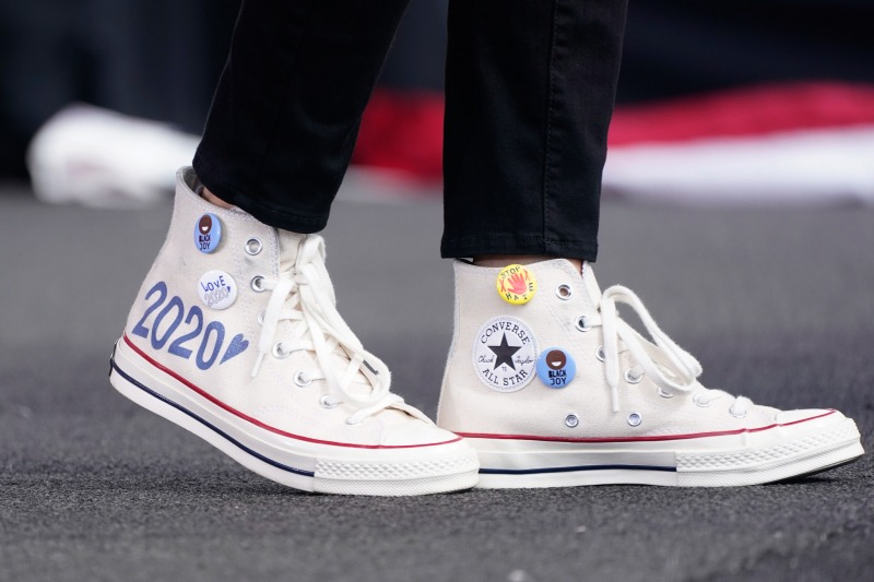 Converse high-top sneakers of Democratic vice presidential candidate Sen. Kamala Harris, D-Calif., are shown as she speaks at a drive-in early voting event, Saturday, Oct. 31, 2020, in Miami, Fla. (AP Photo/Wilfredo Lee)