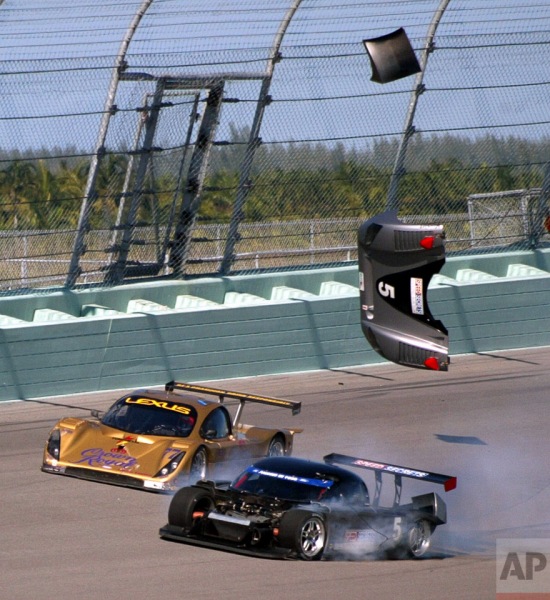 Parts of the number 5 Ford Crawford car, foreground, driven by Justin Pruskowski, fly off as the number 77 Lexus Doran driven by Matteo Bobbi of Italy tries to scoot by during a wreck in the Grand Prix of Miami, Saturday, March 5, 2005, at Homestead-Miami Speedway in Homestead, Fla. (AP Photo/Wilfredo Lee)