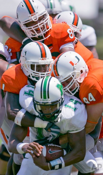 Marshall quarterback Bernard Morris, foreground bottom, is sacked by a mass of Miami players during the first quarter of a football game, Saturday, Sept. 1, 2007, at the Orange Bowl in Miami. (AP Photo/Wilfredo Lee)