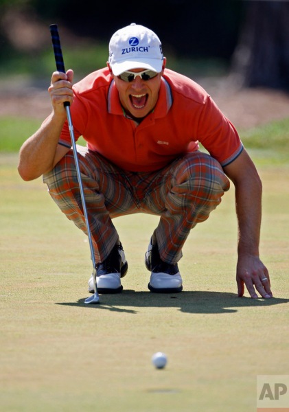 Ben Crane screams at his ball as it stops short of the cup on the 10th green during the third round of The Players Championship golf tournament, Saturday, May 8, 2010, in Ponte Vedra Beach, Fla. (AP Photo/Wilfredo Lee)