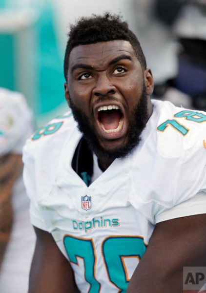Miami Dolphins defensive end Terrence Fede reacts from the bench after watching a play during the second half of an NFL football game against the Baltimore Ravens, Sunday, Dec. 7, 2014 in Miami Gardens, Fla. The Ravens defeated the Dolphins 28-13. (AP Photo/Wilfredo Lee)