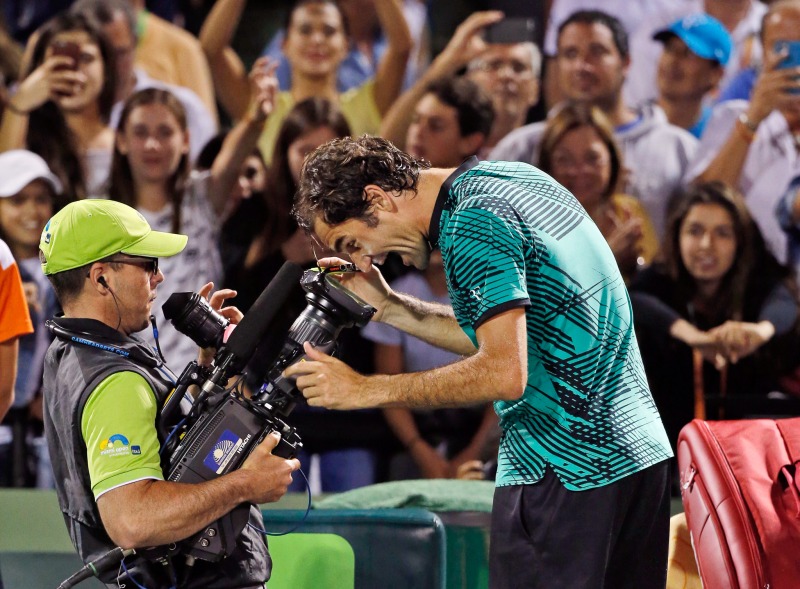 Roger Federer, of Switzerland, clowns for the camera after defeating Nick Kyrgios, of Australia, 7-6 (9) 6-7 (9) 7-6 (5) in a tennis match at the Miami Open, Friday, March 31, 2017 in Key Biscayne, Fla. (AP Photo/Wilfredo Lee)