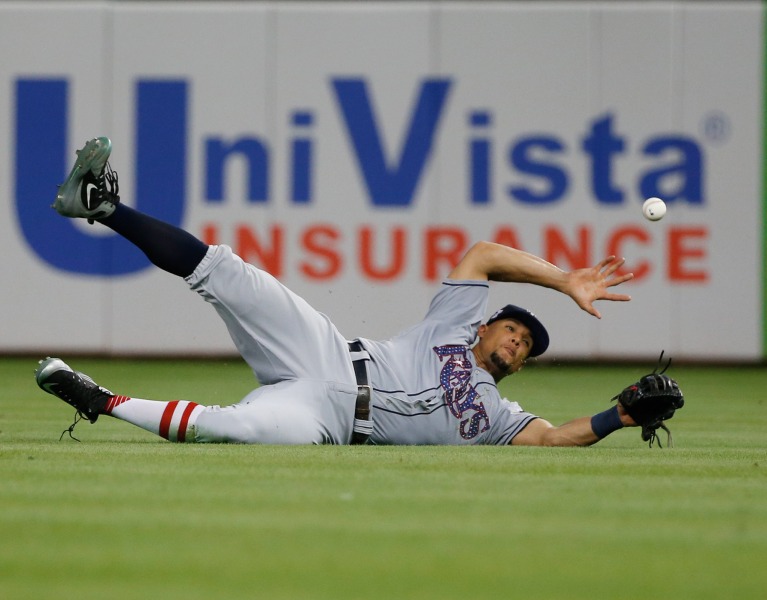 Tampa Bay Rays right fielder Carlos Gomez is unable to catch a ball hit by Miami Marlins' Miguel Rojas during the 10th inning of a baseball game Tuesday, July 3, 2018, in Miami. The Rays defeated the Marlins 9-6 in 16 innings. (AP Photo/Wilfredo Lee)