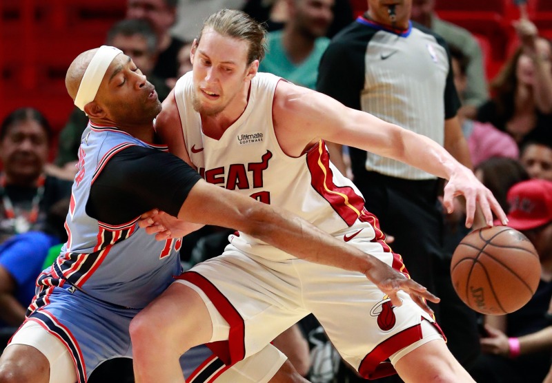 Atlanta Hawks forward Vince Carter, left, swats the ball away from Miami Heat forward Kelly Olynyk during the first half of an NBA basketball game, Monday, March 4, 2019, in Miami. (AP Photo/Wilfredo Lee)