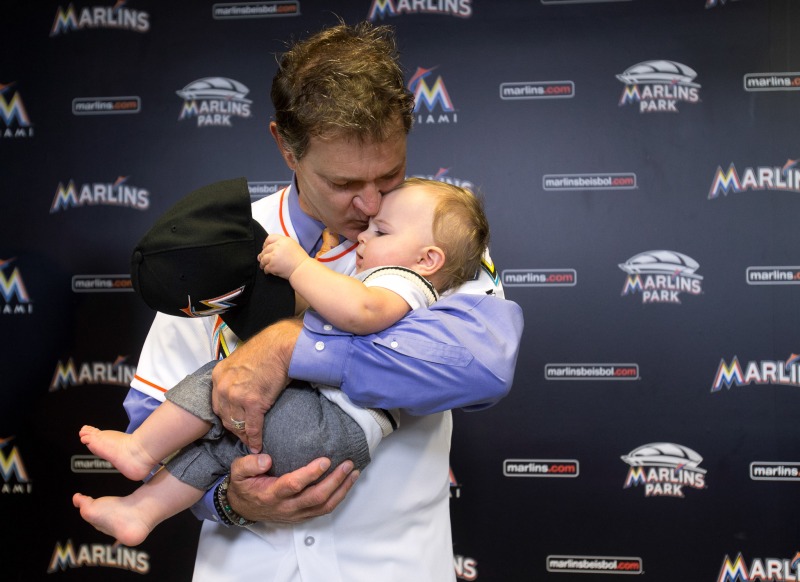 Don Mattingly kisses his son Louie after being introduced as the new Miami Marlins baseball team manager, Monday, Nov. 2, 2015, in Miami. (AP Photo/Wilfredo Lee)