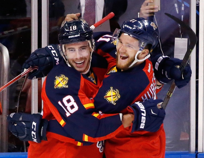 Florida Panthers right wing Reilly Smith (18) and left wing Jonathan Huberdeau (11) celebrate after Smith scored during the first period of Game 2 in a first-round NHL hockey Stanley Cup playoff series against the New York Islanders, Friday, April 15, 2016, in Sunrise, Fla. (AP Photo/Wilfredo Lee)