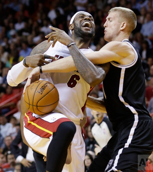 Miami Heat forward LeBron James (6) is fouled by Brooklyn Nets forward Mason Plumlee as he goes up for a shot during the first half of an NBA basketball game, Tuesday, April 8, 2014 in Miami. (AP Photo/Wilfredo Lee, File)