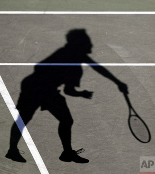 Switzerland's Roger Federer's shadow appears as he serves to Arnaud Clement ,of France, at the Nasdaq-100 Open tennis tournament, Saturday, March 25, 2006, in Key Biscayne, Fla. Federer defeated Clement, 6-2, 6-7 (4-7), 6-0. (AP Photo/Wilfredo Lee)