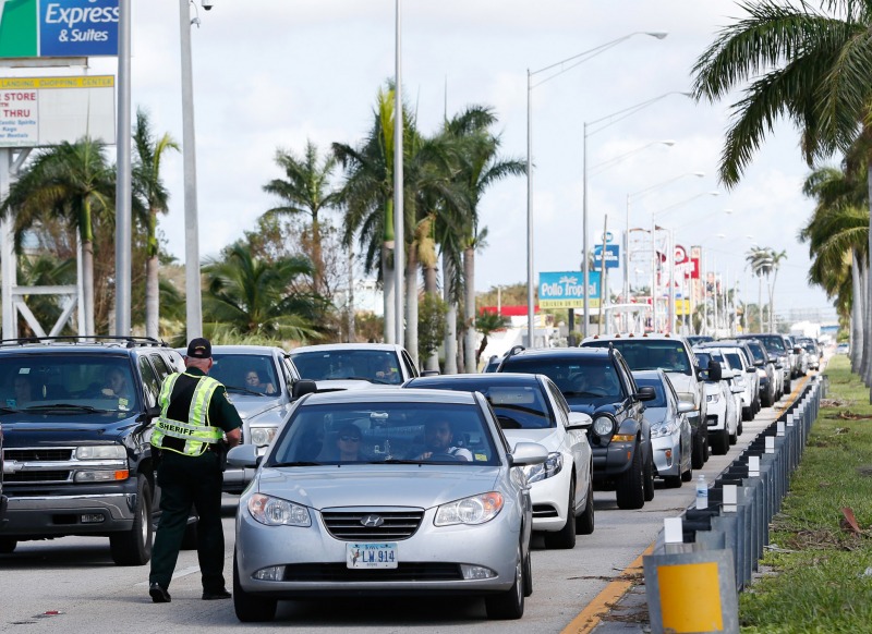 A police officer directs motorists at a checkpoint as Florida Keys residents return to their homes in the upper keys, Tuesday, Sept. 12, 2017, in Florida City, Fla. (AP Photo/Wilfredo Lee)